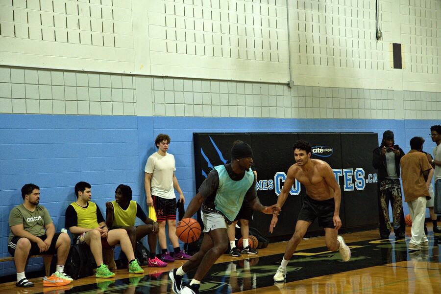 A drive to the basket while the next team waits on the bench