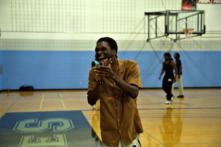 Our host laughing and clapping on the sideline